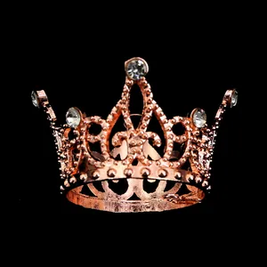 Macro detail of a mini rose gold crown with rhinestones for cake decor and party styling