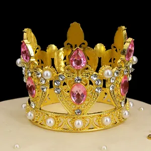 Macro shot of gold alloy mini crown with pink waterdrop crystals and white pearls