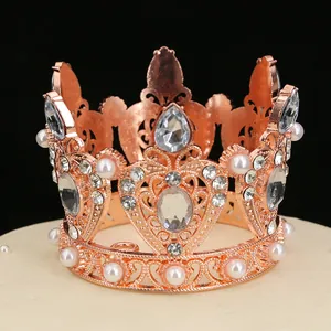 Exquisite rose gold flower crown cake topper with pearls and zircons on black background