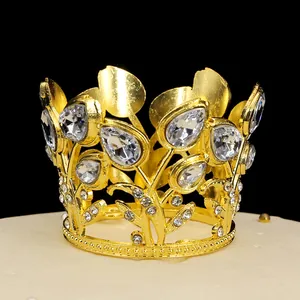 Close-up of golden hollow crown with tulip buds and rhinestones for cake decoration