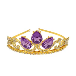 Detail of golden girls crown with large purple teardrop gemstones and white rhinestones