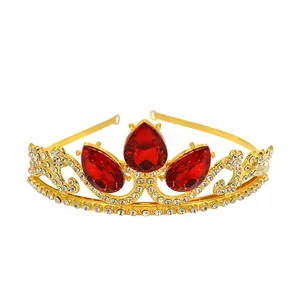 Close-up of golden crown with red teardrop rhinestones and sparkling crystals for girls