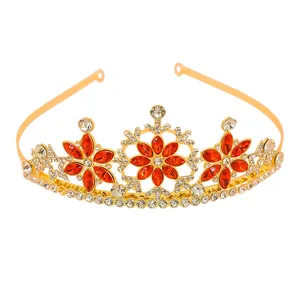 Detail view of golden crown with red marquise rhinestones and white snowflake accents
