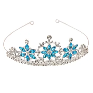 Detailed view of silver snowflake tiara with light blue crystals for parties