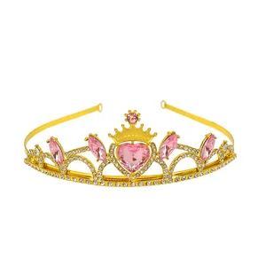Detail of gold princess crown with pink heart gemstone and sparkling white rhinestones
