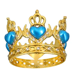 Close-up of golden crown with blue heart crystals and sparkling white rhinestones