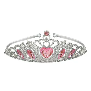 Detail of silver crown headpiece featuring a pink heart-shaped crystal and rhinestones