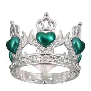Detailed view of silver alloy crown ring featuring green heart gems and white crystals