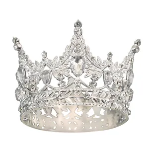 Detailed view of silver alloy tiara featuring intricate leaf patterns and sparkling rhinestones