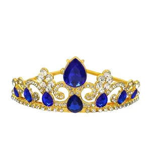Detailed view of golden princess crown featuring teardrop blue gems and white crystals
