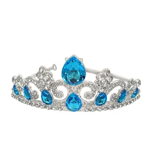 Close-up of silver crown with blue teardrop gemstones and micro-paved white rhinestones