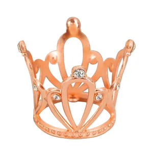 Macro view of rose gold alloy mini crown with heart pattern and white rhinestones