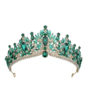 Macro detail of luxury gold bridal tiara featuring emerald green crystals and rhinestones