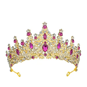 Close-up of gold bridal tiara featuring teardrop pink crystals and intricate rhinestones