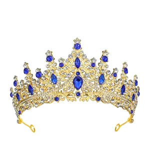 Detailed close-up of golden crown featuring blue teardrop gemstones and white crystals