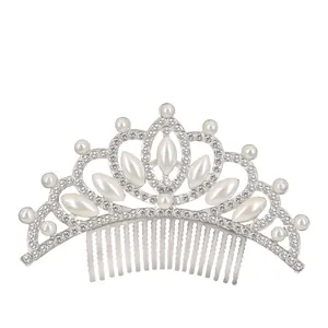 Detail of silver tiara comb with white pearls and sparkling rhinestones for girls