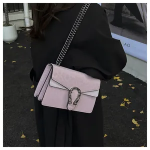 Detailed view of lavender chain bag with silver tiger head buckle and leopard pattern