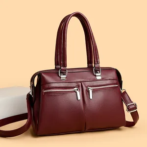 Burgundy litchi leather handbag with multiple pockets and silver hardware from a 45-degree angle