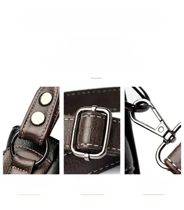 Macro shot of polished silver-tone metal rings and adjustable hooks on faux leather bag