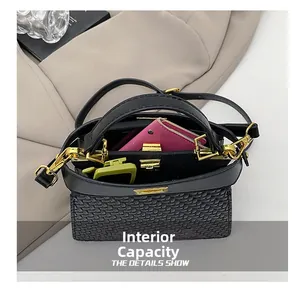 Top view of black woven shoulder bag interior showing capacity with wallet and sunglasses