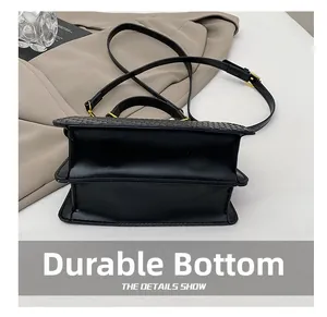 Detail showing wear-resistant bottom structure of vintage black crocodile pattern handbag