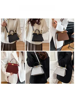 Detail view of woven textured trapezoid handbags in four colors with gold metal clasps