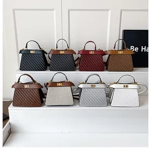 Various colors of woven leather trapezoid handbags with metal twist locks and top handles