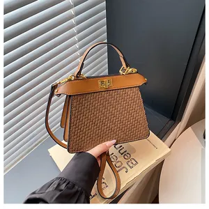 Close-up of retro brown woven texture bag with golden twist lock and leather strap