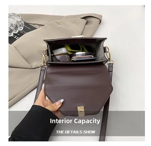 Internal capacity detail of dark brown tote bag showing main compartment and zip pocket