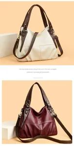 Detail view of large tote bags in beige and wine red with lychee texture and stitching