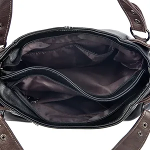 Internal view showing multiple compartments and zipper pockets of the large shoulder bag
