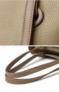 Détail de la texture cuir marron avec motif litchi, coutures et finitions soignées