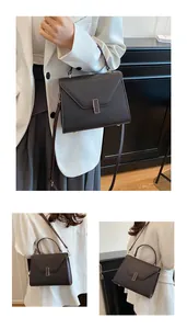 Detail of dark brown pebble leather tote bag with envelope flap and metal clasp