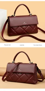 Detailed view of wine red cowhide handbag featuring classic quilted rhombus pattern and leather