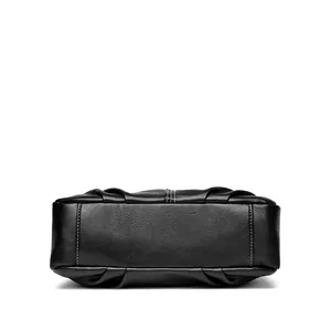 Close-up of black lychee leather handbag base with white contrast stitching detail