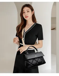 Close-up of black quilted leather handbag featuring silver hardware and a single handle