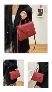 Close-up of red lychee pattern leather tote bag with gold buckle and adjustable strap