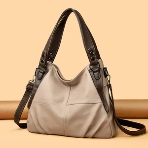 Detail view of large two-tone beige and brown tote bag with premium lychee grain PU leather
