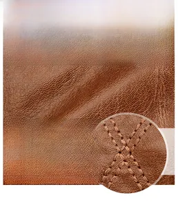 Détail du similicuir marron grainé vintage avec coutures renforcées pour sac de moto