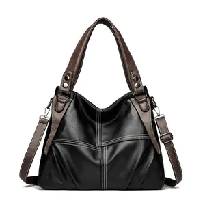 Minimalist black and brown vintage tote bag with contrast stitching and silver hardware