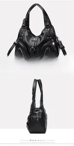 Detail view of black lychee grain faux leather handbag with metal rings and zippers