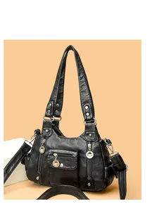 Detail of black washed PU leather handbag featuring multiple pockets and bee pendant zipper