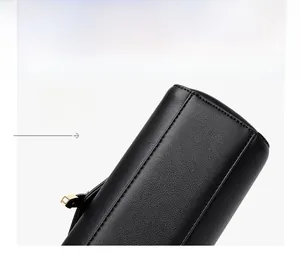 Detail of black pebbled leather handbag bottom featuring precision stitching and texture