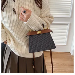 Close-up of retro crocodile texture crossbody bag with gold hardware and leather strap