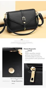 Detail of the golden U-shaped buckle and fine lychee texture on the black shoulder bag