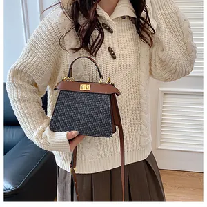 Detail of woven fabric texture and premium brown leather handle on a vintage handbag