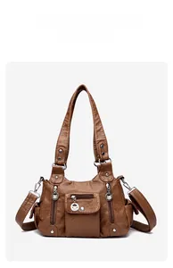 Front angle view of brown washed PU leather handbag with multiple zipper pockets