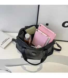 Interior view showing large capacity for tablets, wallet and water in black tote bag