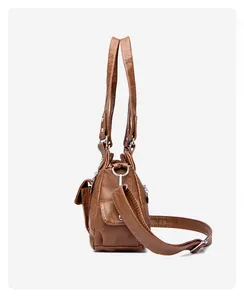 Detail view of brown washed PU leather handbag with side pocket and silver hardware