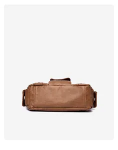 Detail view of the flat bottom and fine stitching on a dark brown vintage PU leather bag